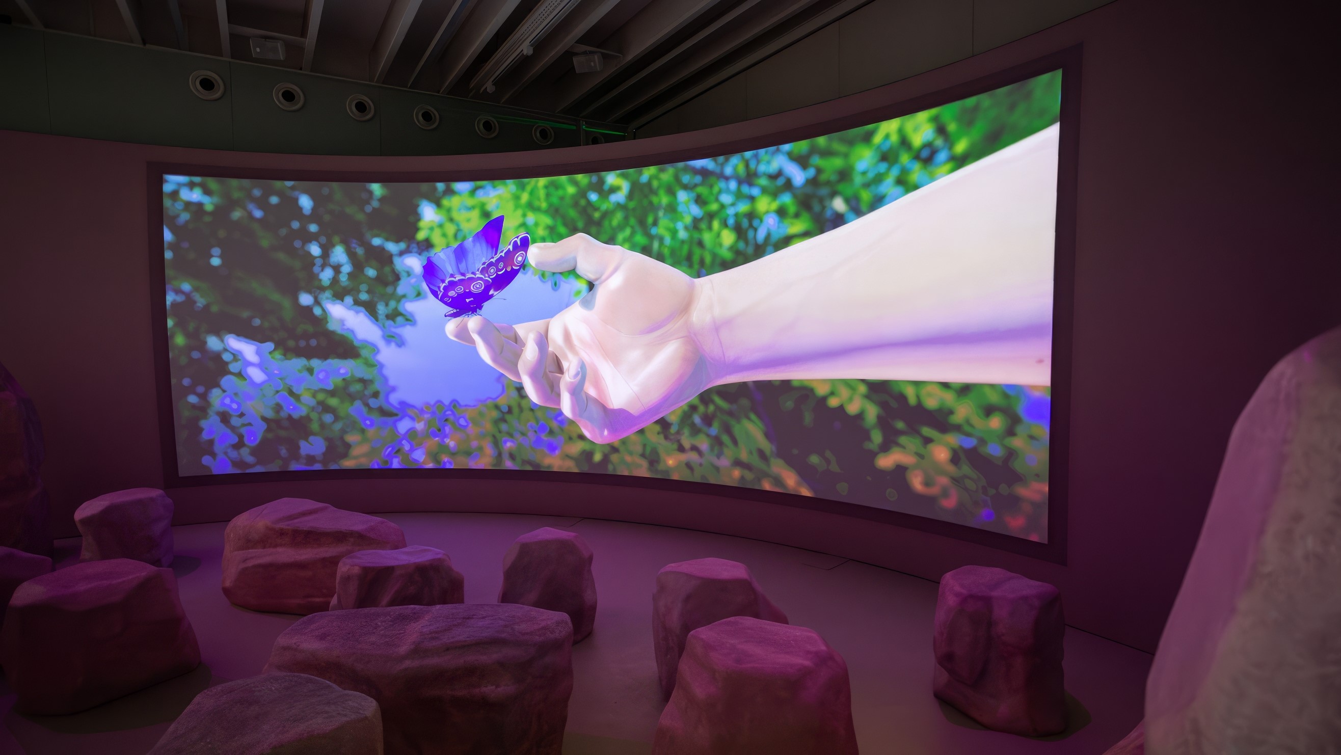 Photo of exhibition with wide video installation screen